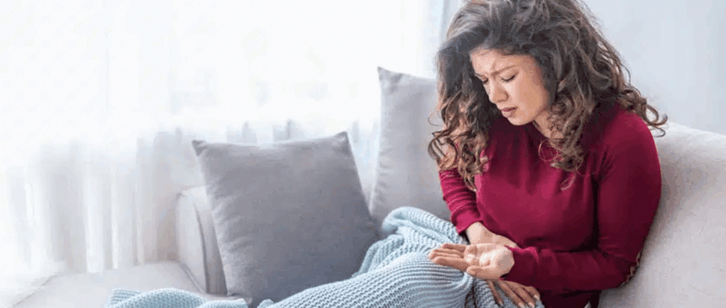 Woman experiencing opiate withdrawal symptoms at home while considering the Thomas Recipe for relief.